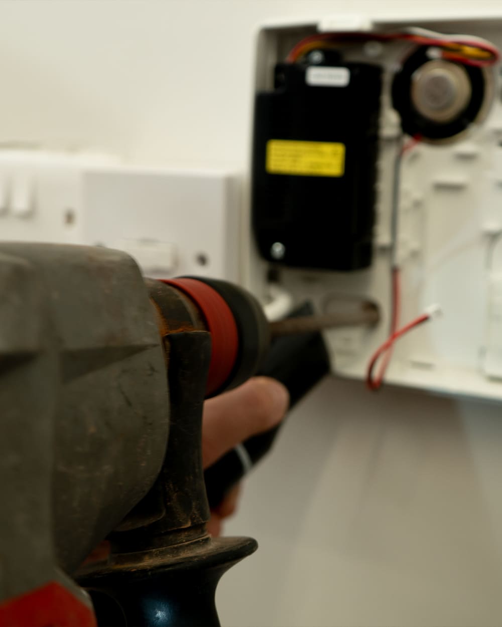 Engineer installing an alarm control panel