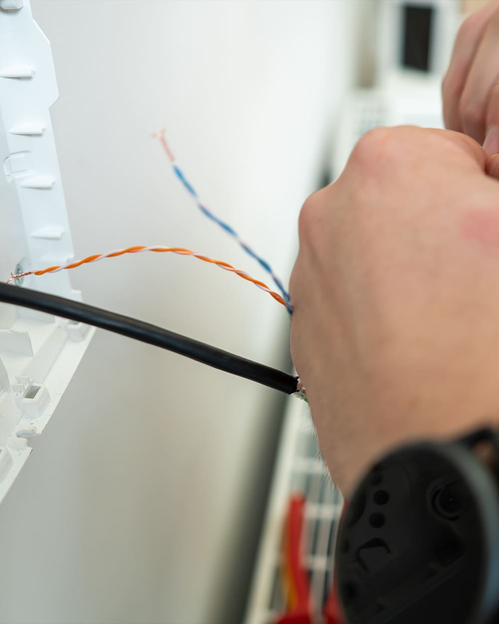 Engineer terminating cable for a CCTV installation